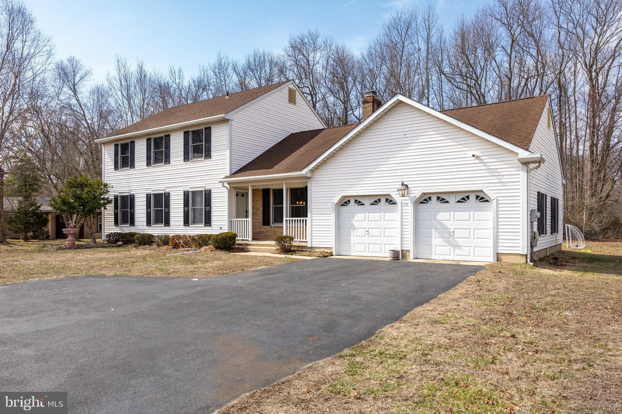 14 Taunton Road Medford, NJ 08055 - Photo 3 of 47 a front view of a house with a yard and garage