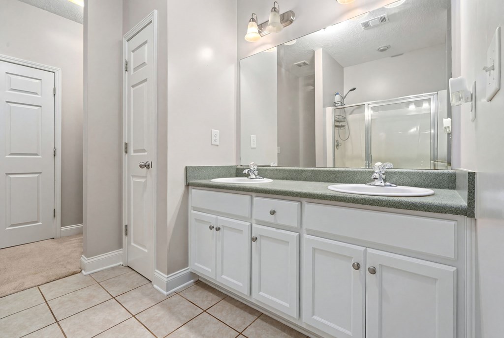 934 Ga Highway Fortson, GA 31808 - Photo 15 of 19 a bathroom with a granite countertop sink two mirror and a