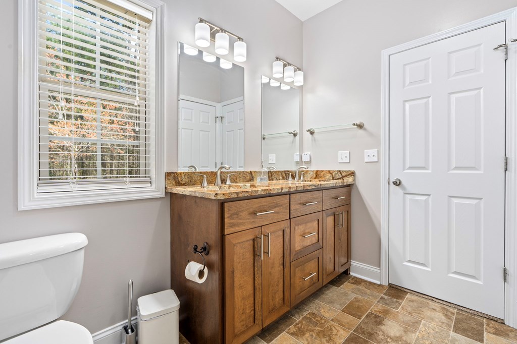 934 Ga Highway Fortson, GA 31808 - Photo 18 of 19 a spacious bathroom with a granite countertop toilet sink and mirror
