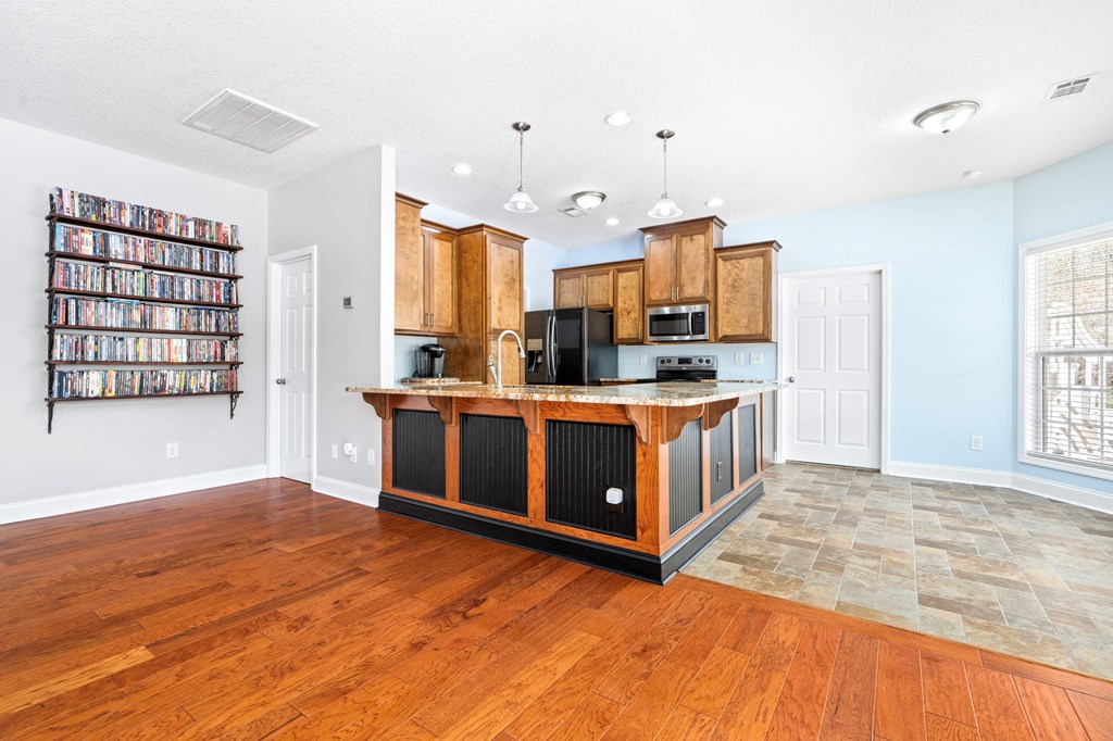 934 Ga Highway Fortson, GA 31808 - Photo 6 of 19 a kitchen with stainless steel appliances a stove top oven a sink a counter space and windows