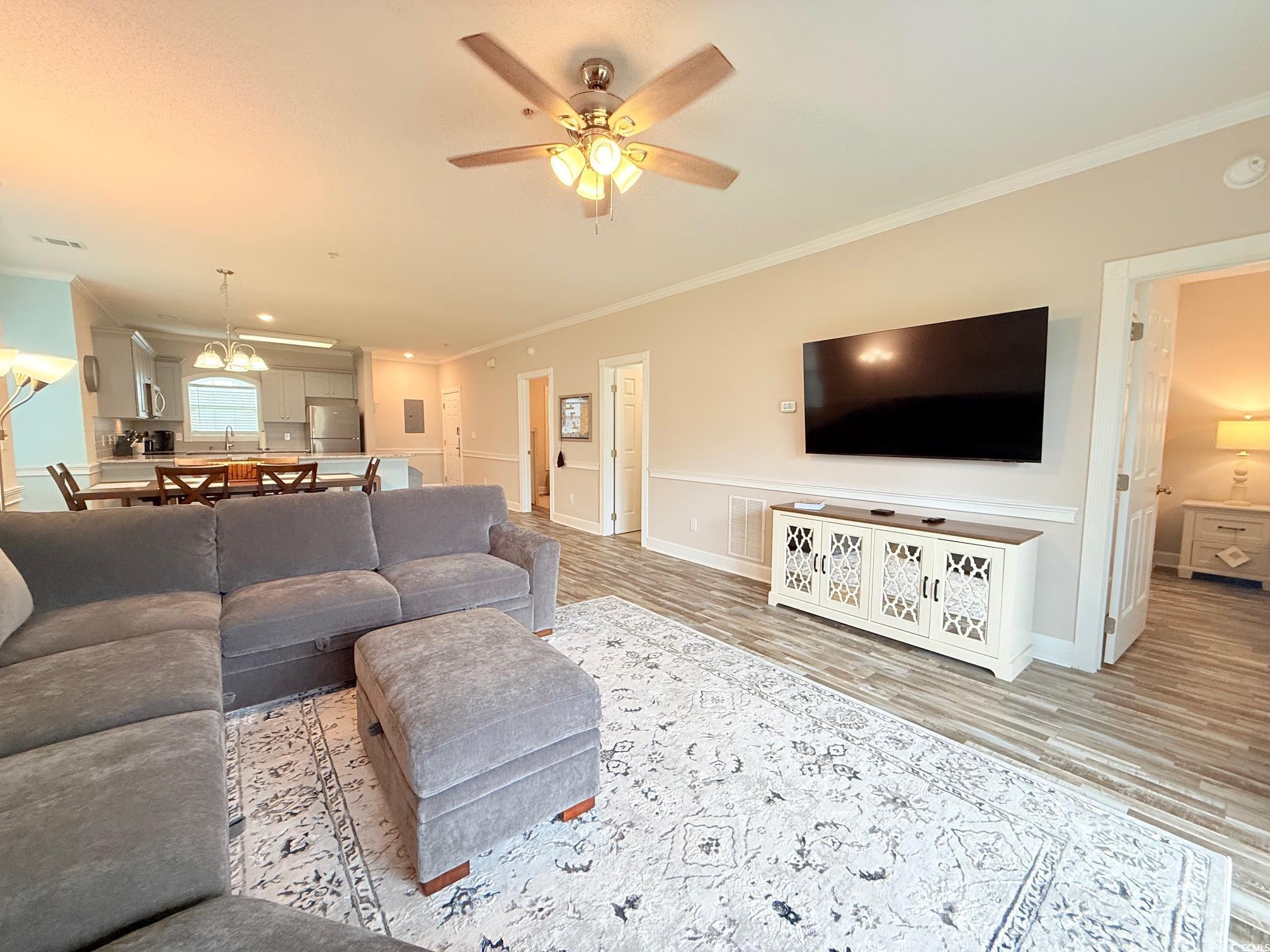 4860 Carnation Circle, Unit 17105 Myrtle Beach, SC 29577 - Photo 12 of 29 Living area with crown molding, light wood-style flooring, and ceiling fan