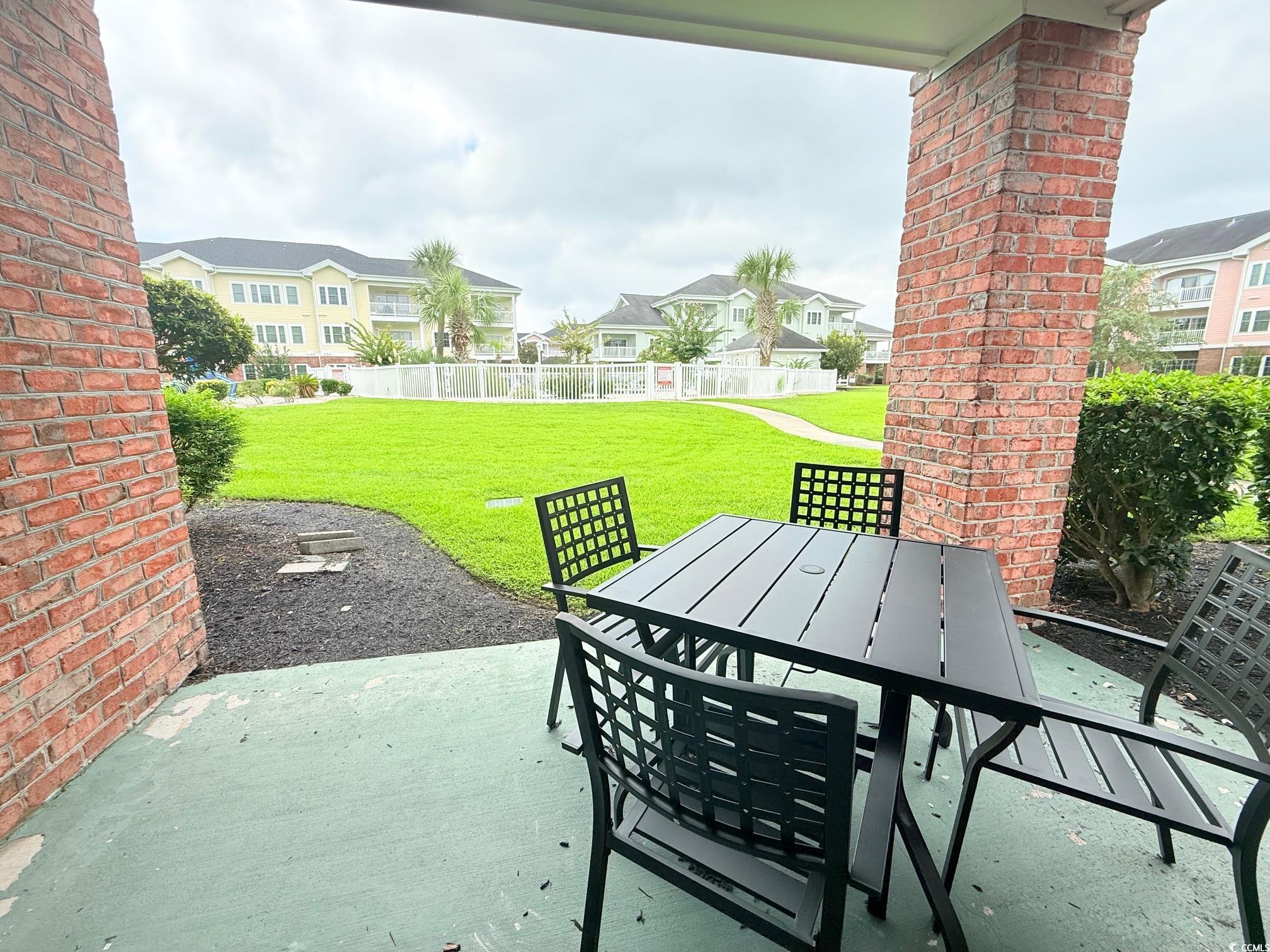 4860 Carnation Circle, Unit 17105 Myrtle Beach, SC 29577 - Photo 25 of 29 Fenced backyard with a patio, outdoor dining space, and a residential view