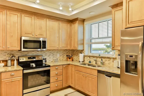a kitchen with stainless steel appliances a stove sink microwave and cabinets