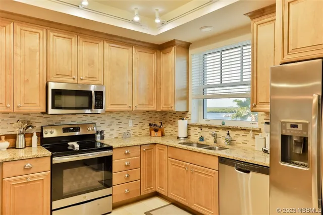 a kitchen with stainless steel appliances a stove sink microwave and cabinets