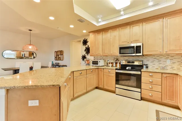 a kitchen with granite countertop a sink stainless steel appliances and cabinets
