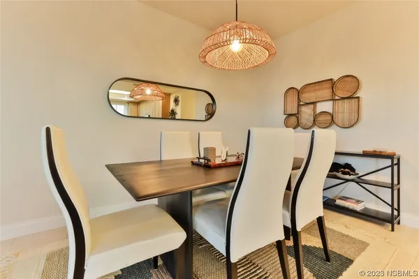 a view of a dining room with furniture and chandelier