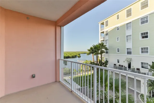 a balcony with furniture and a gate