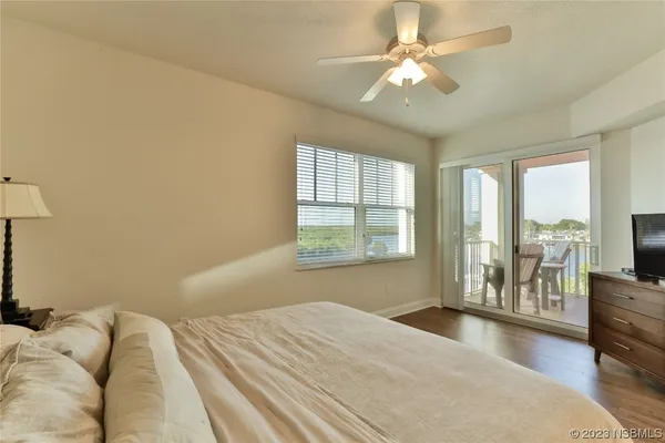 a bedroom with a large bed and a tv