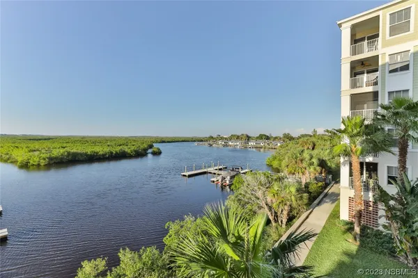 a view of a lake with houses in the back