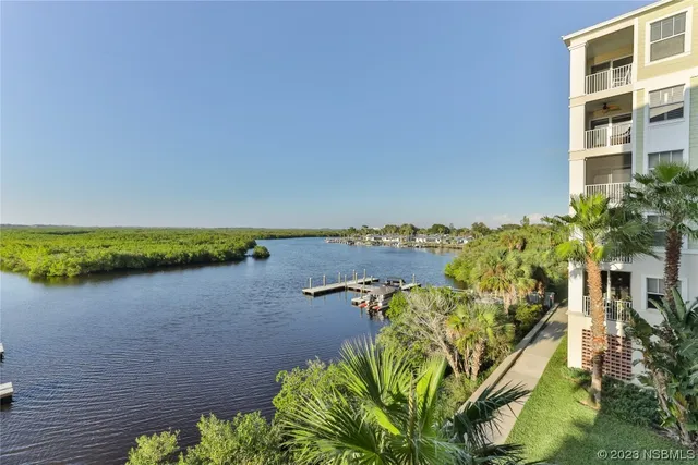 a view of a lake with houses in the back