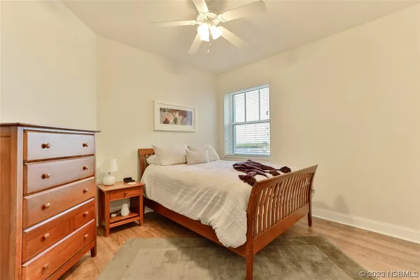 a bedroom with a bed and a lamp