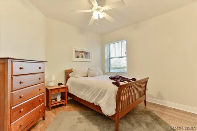 a bedroom with a bed and a lamp