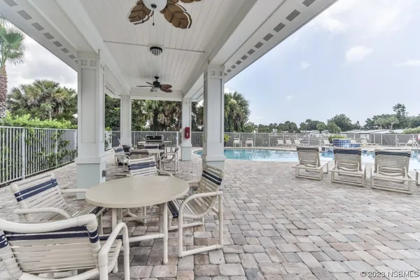 a view of a chair and tables in the balcony