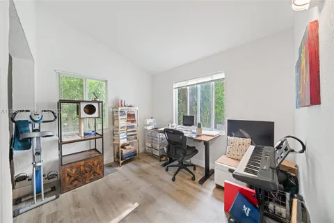 a living room with furniture a flat screen tv and a window