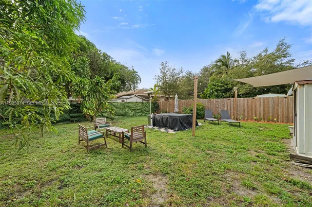 a view of backyard with seating and green space