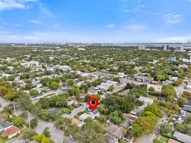 an aerial view of a houses with a city