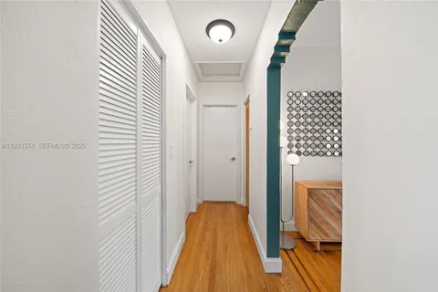 a view of hallway with wooden floor