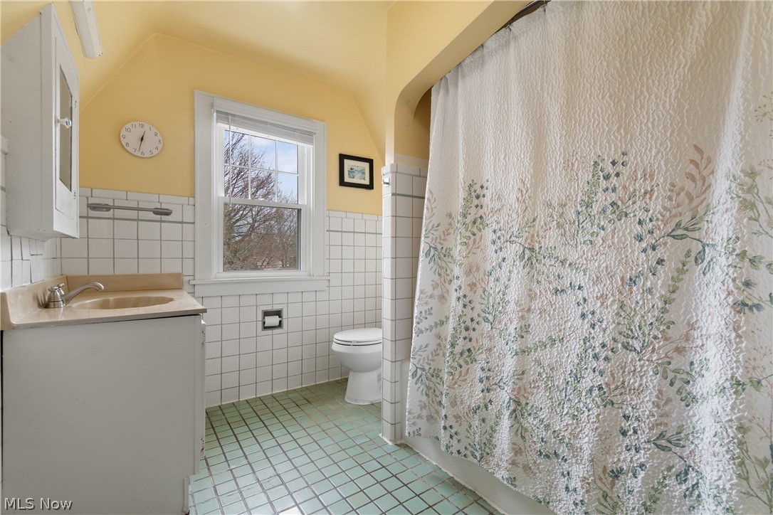 2214 Cleveland Road Wooster, OH 44691 - Photo 23 of 38 A closer look at Main Bath. To the right is the tub AND shower. Notice the original mirror and the home made medicine cabinet over the sink.