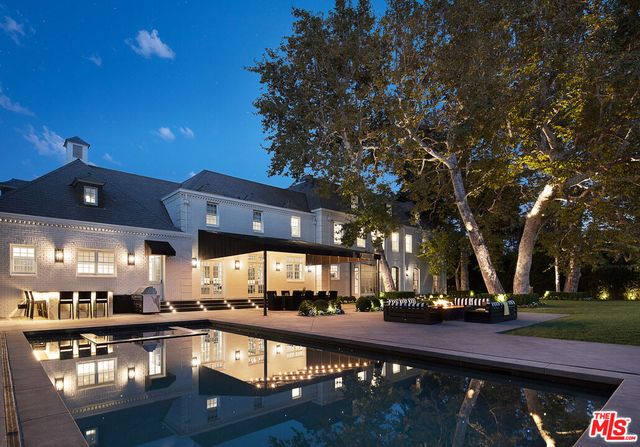 a view of a swimming pool with outdoor seating and a patio