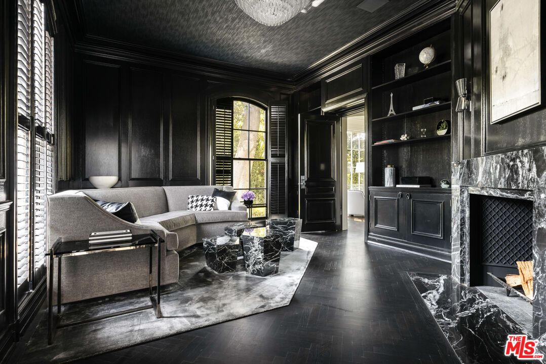 301 Copa De Oro Road Los Angeles, CA 90077 - Photo 11 of 33 a living room with lots of furniture and gym equipment