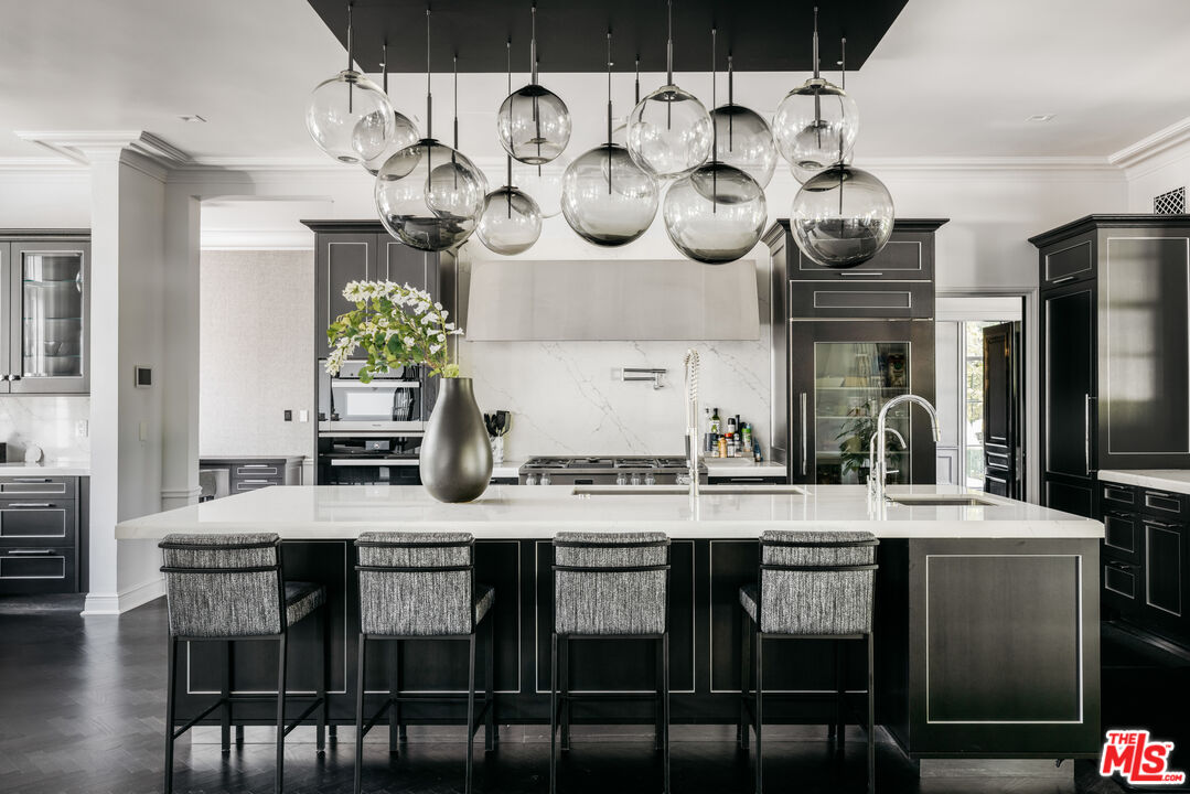 301 Copa De Oro Road Los Angeles, CA 90077 - Photo 14 of 33 a kitchen with a dining table and chairs