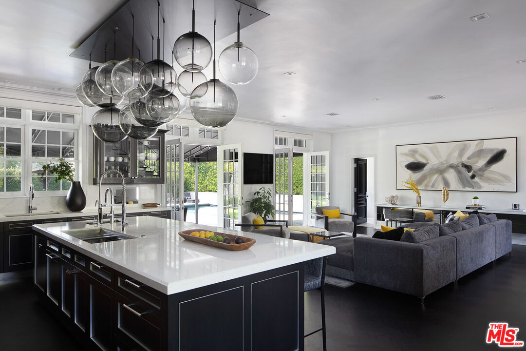 301 Copa De Oro Road Los Angeles, CA 90077 - Photo 16 of 33 a kitchen with counter top space and living room view