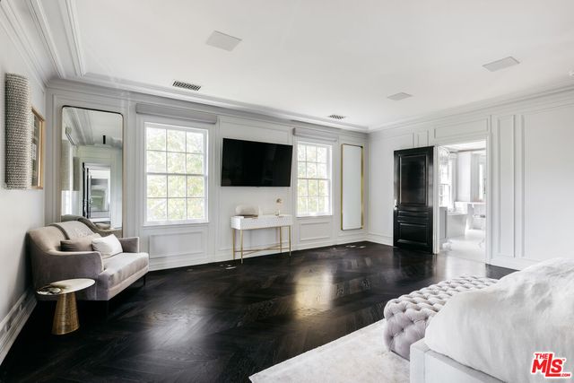 a living room with furniture window and wooden floor