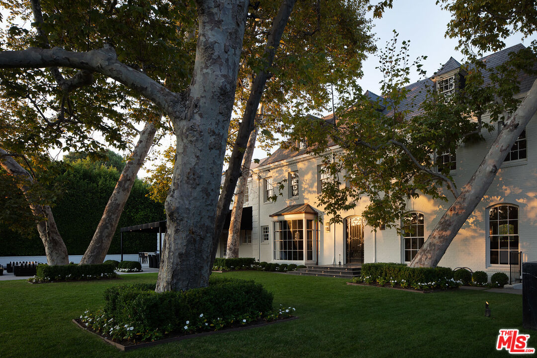 301 Copa De Oro Road Los Angeles, CA 90077 - Photo 31 of 33 a front view of a house with a garden