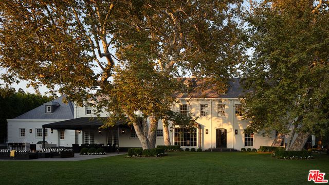 a front view of a building with a garden