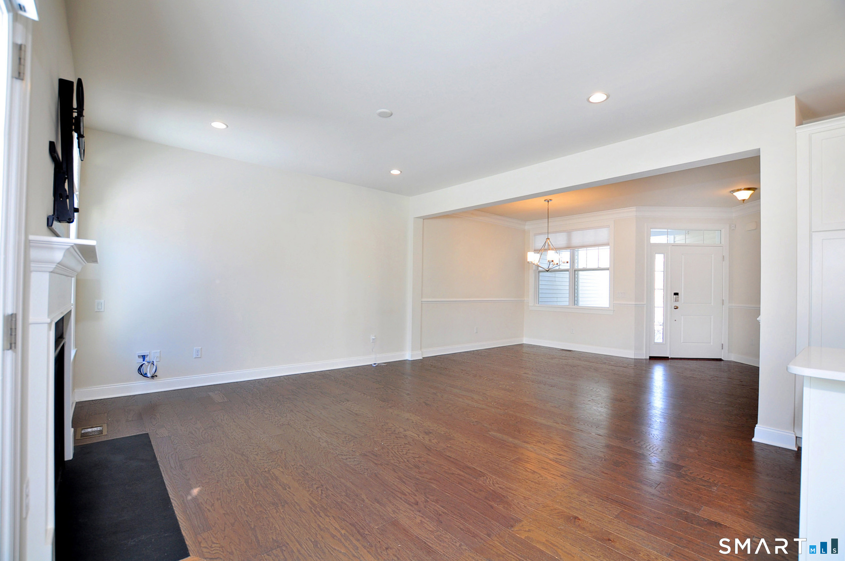 149 Ridgewood Drive Middlebury, CT 06762 - Photo 12 of 30 an empty room with wooden floor and windows