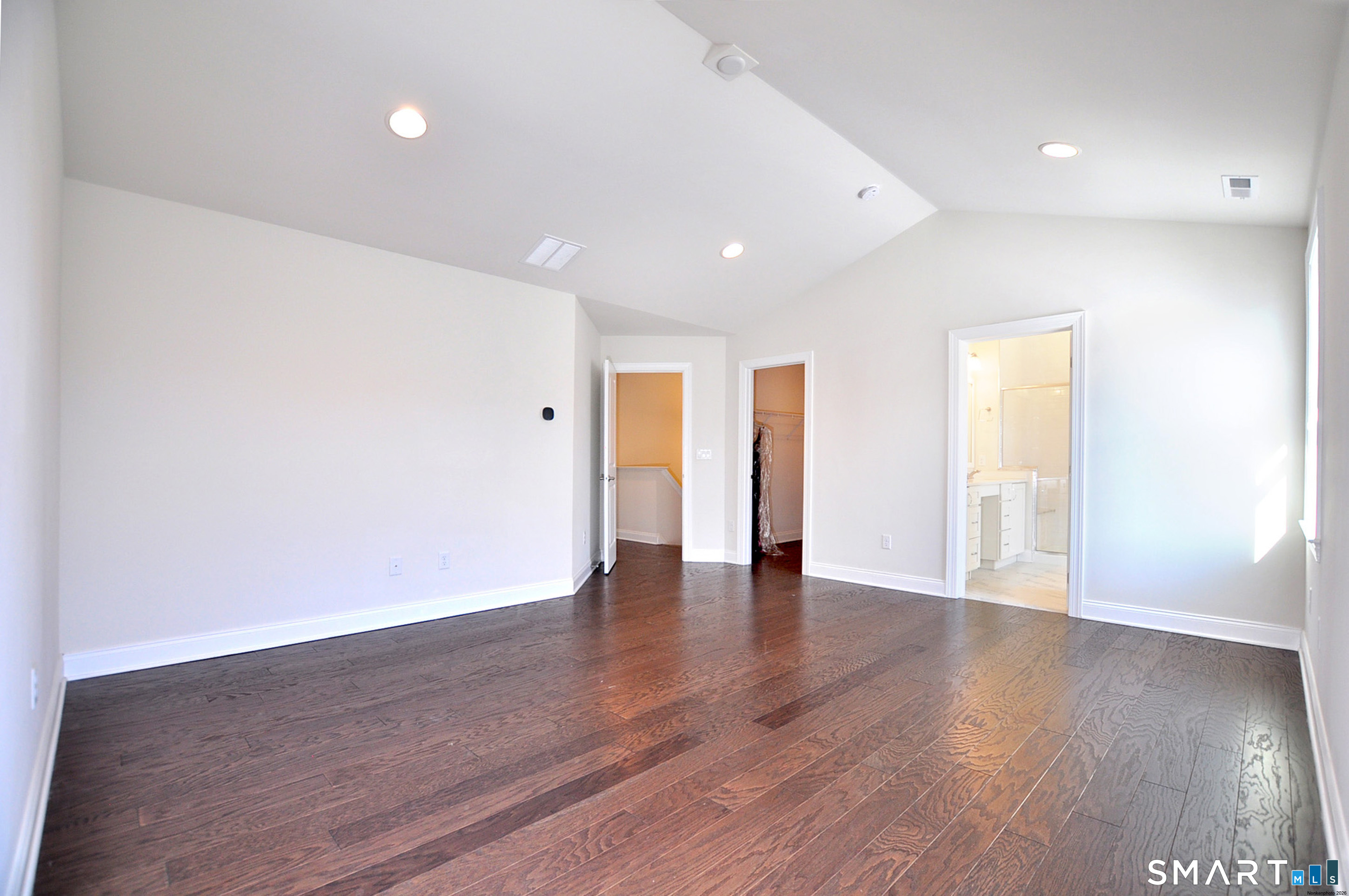 149 Ridgewood Drive Middlebury, CT 06762 - Photo 15 of 30 a view of an empty room with wooden floor and a window