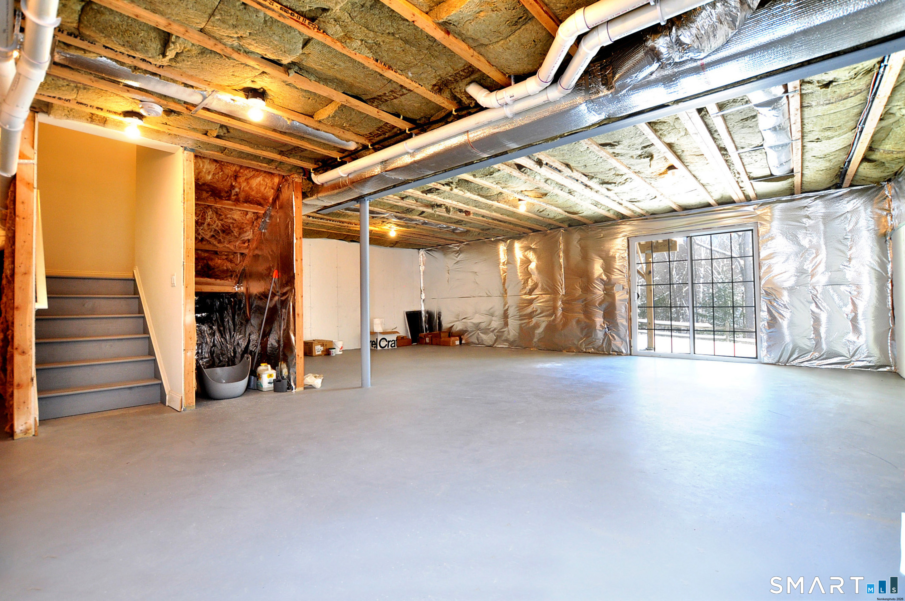 149 Ridgewood Drive Middlebury, CT 06762 - Photo 27 of 30 a view of an empty room with wooden floor and windows