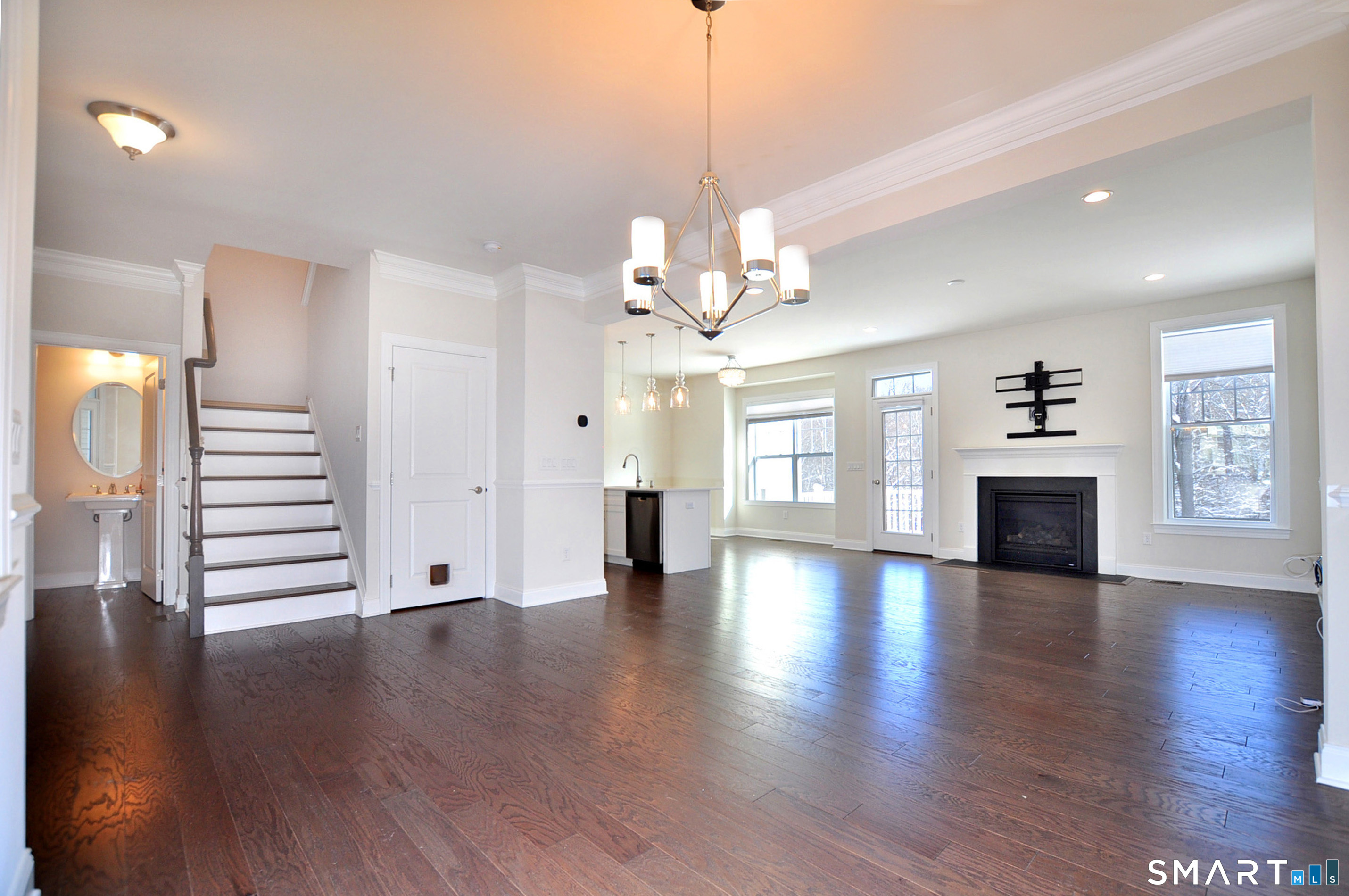 149 Ridgewood Drive Middlebury, CT 06762 - Photo 5 of 30 a view of a livingroom with fireplace wooden floor and windows