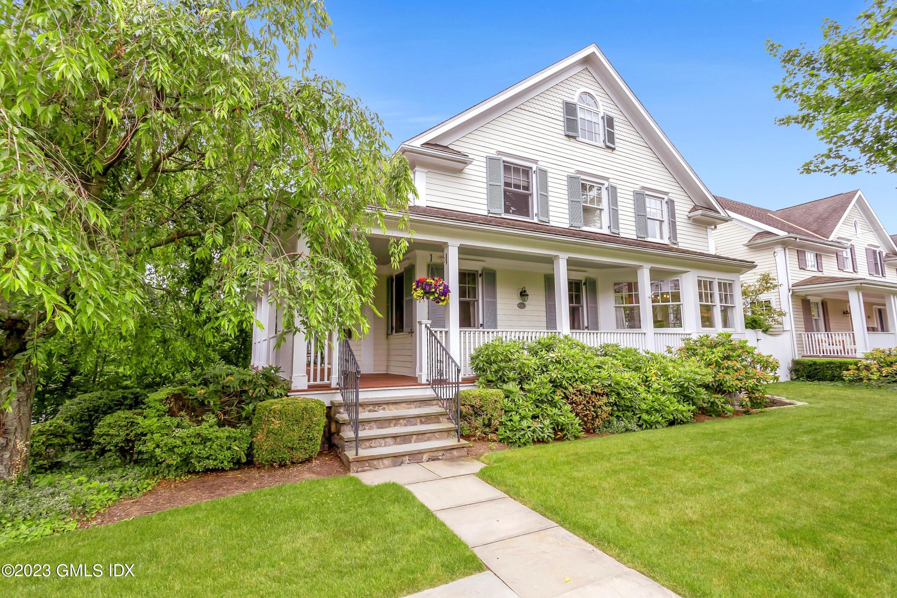 124 East Elm Street, Unit WEST Greenwich, CT 06830 - Photo 1 of 23 a front view of a house with a yard
