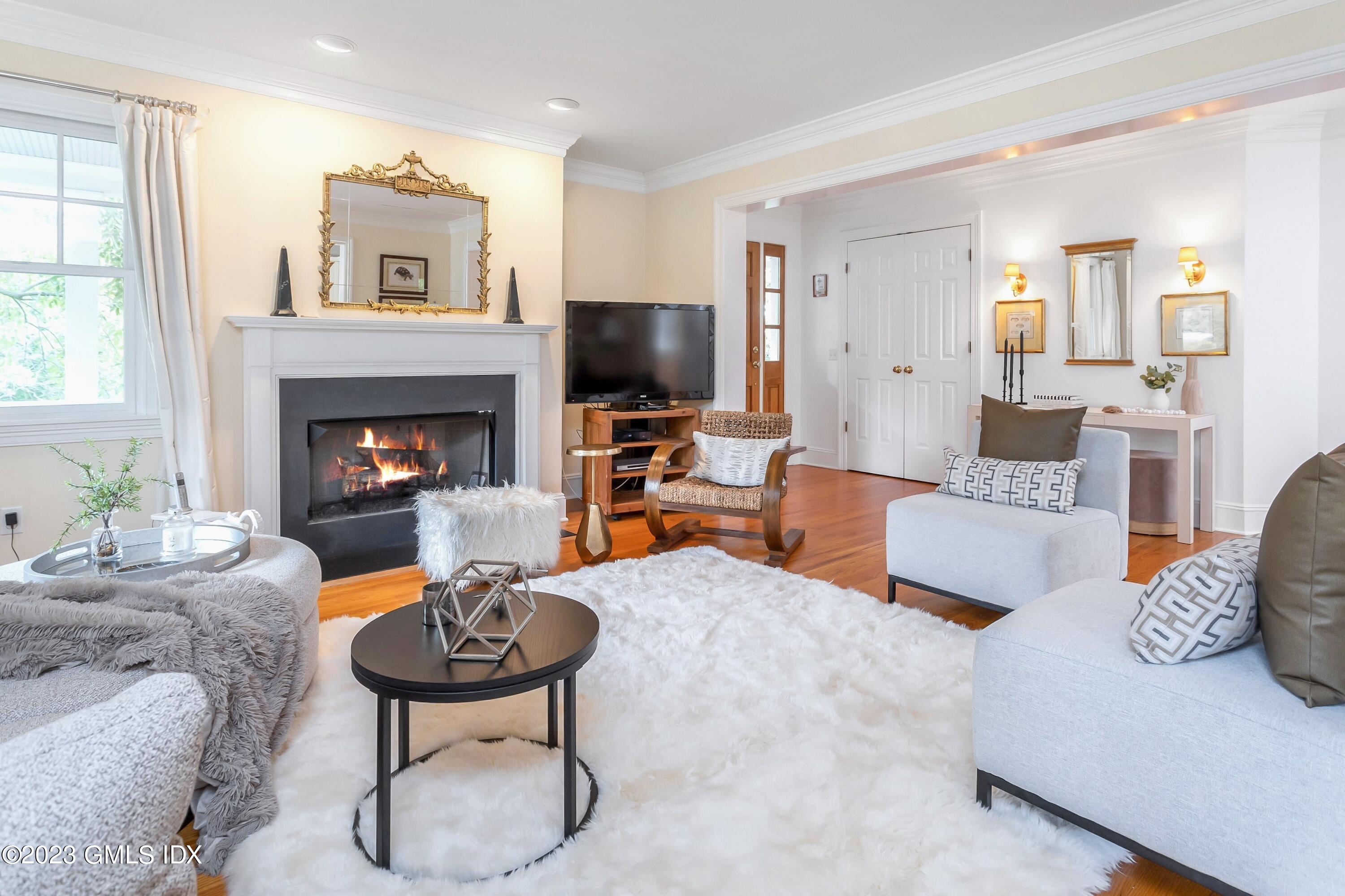 124 East Elm Street, Unit WEST Greenwich, CT 06830 - Photo 11 of 23 a living room with furniture and a fireplace