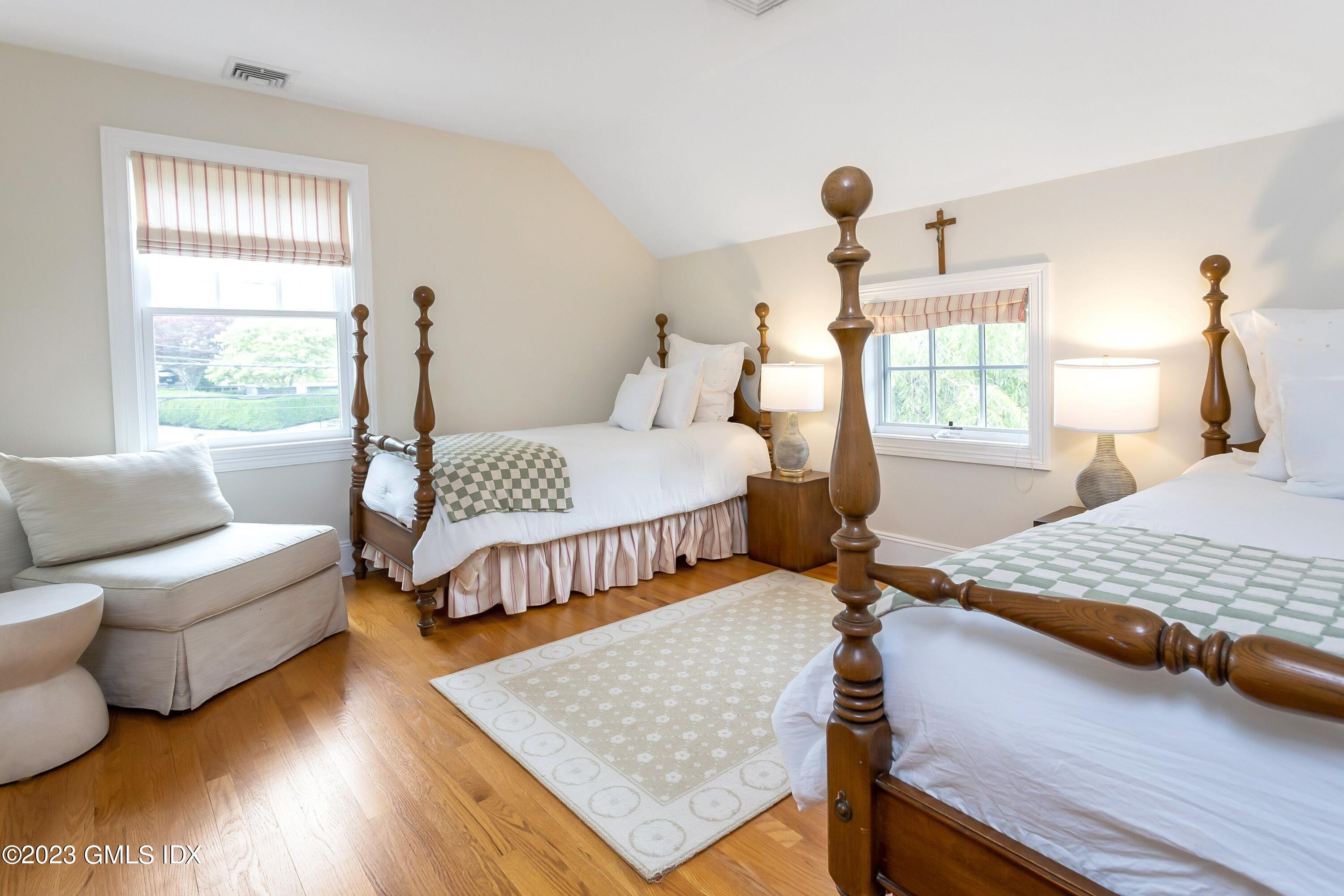 124 East Elm Street, Unit WEST Greenwich, CT 06830 - Photo 14 of 23 a bedroom with a bed and wooden floor