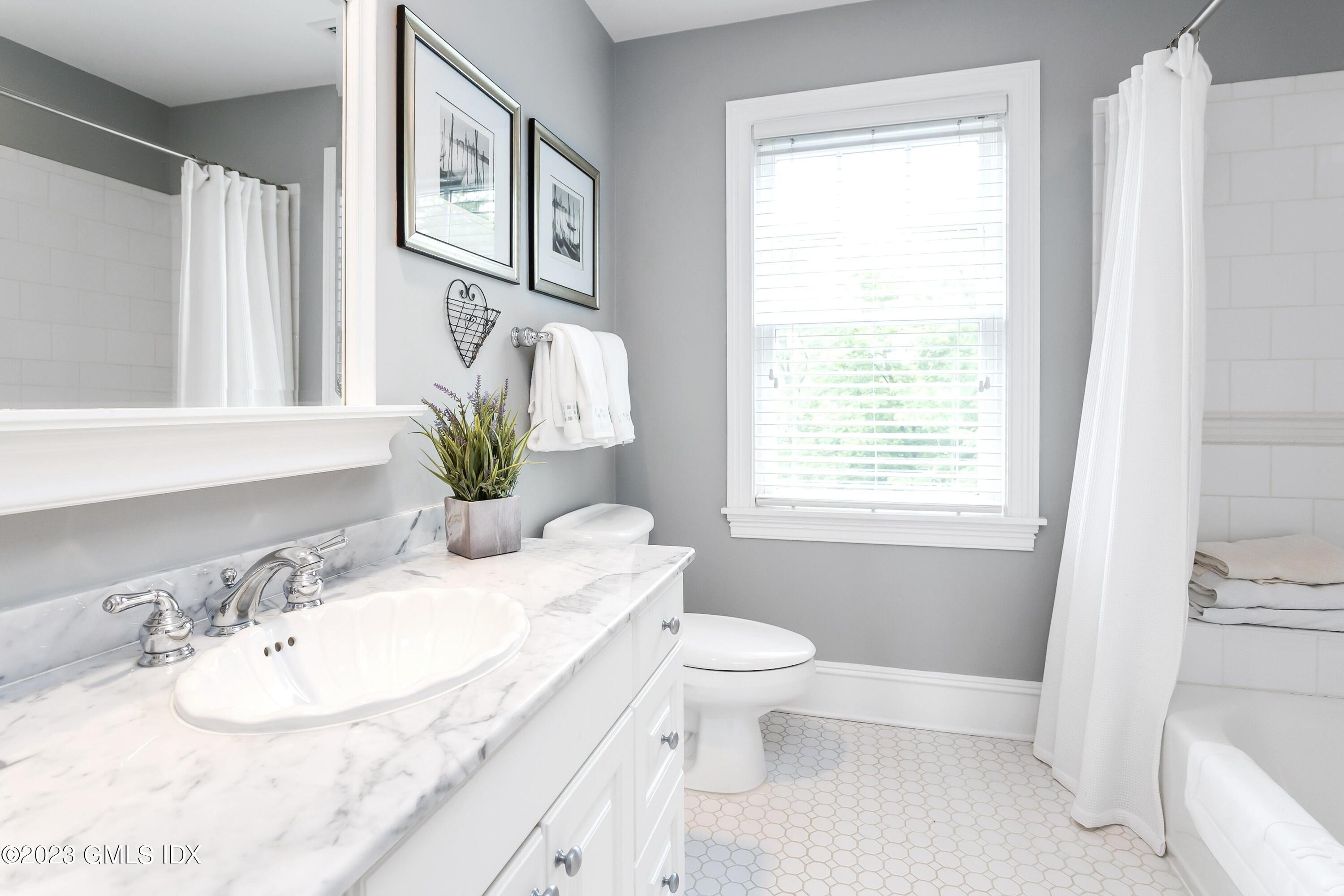 124 East Elm Street, Unit WEST Greenwich, CT 06830 - Photo 15 of 23 a bathroom with a granite countertop sink and a mirror