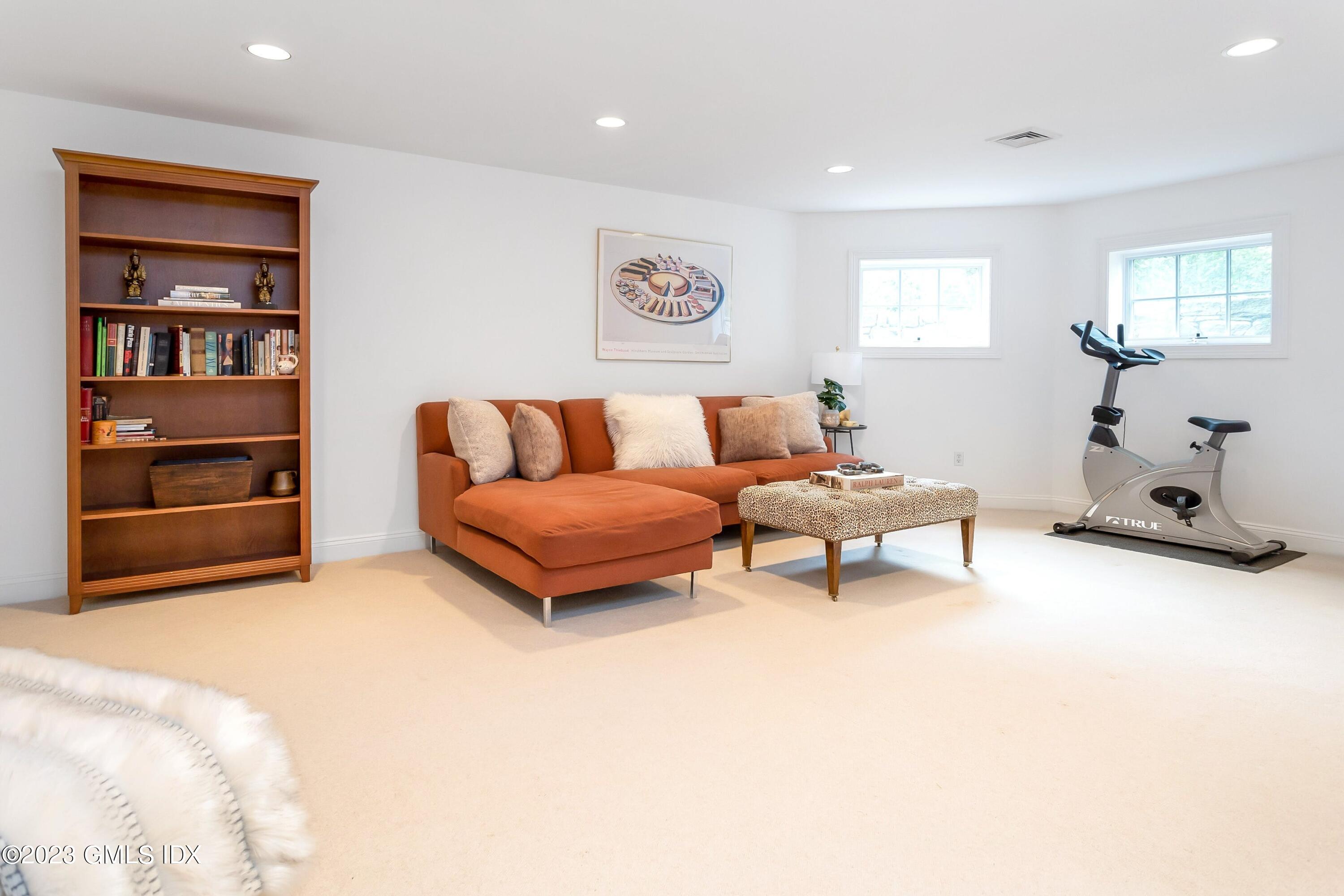 124 East Elm Street, Unit WEST Greenwich, CT 06830 - Photo 17 of 23 a living room with furniture and a book shelf