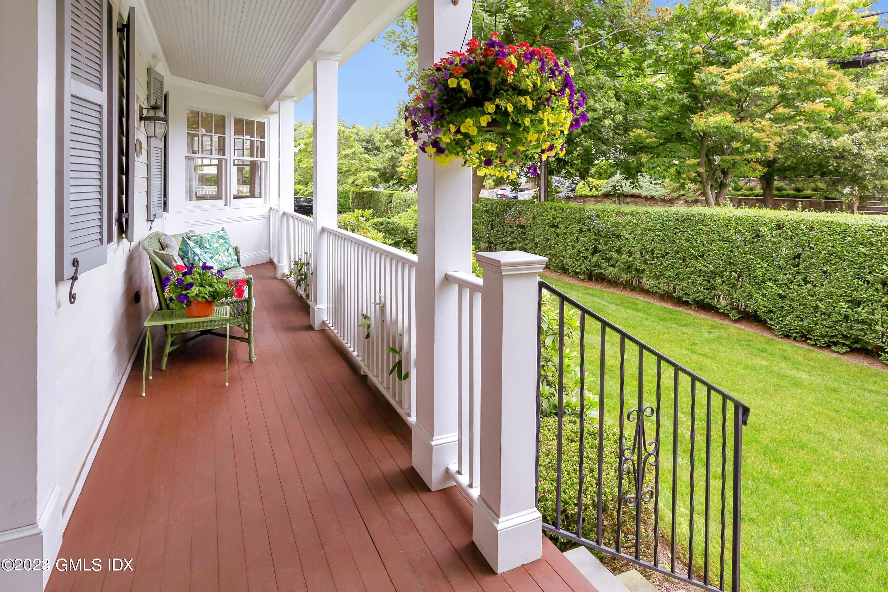 124 East Elm Street, Unit WEST Greenwich, CT 06830 - Photo 2 of 23 a view of a porch with wooden floor and fence