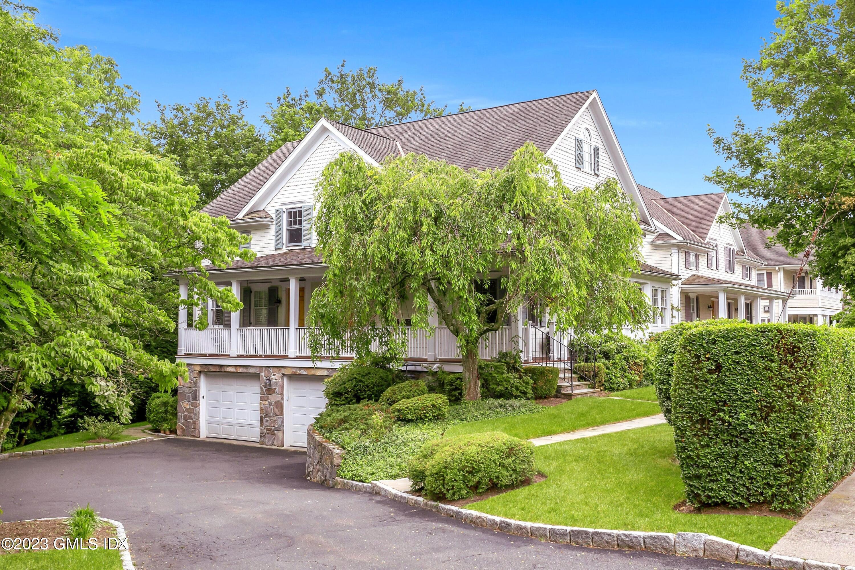 124 East Elm Street, Unit WEST Greenwich, CT 06830 - Photo 4 of 23 a front view of a house with garden