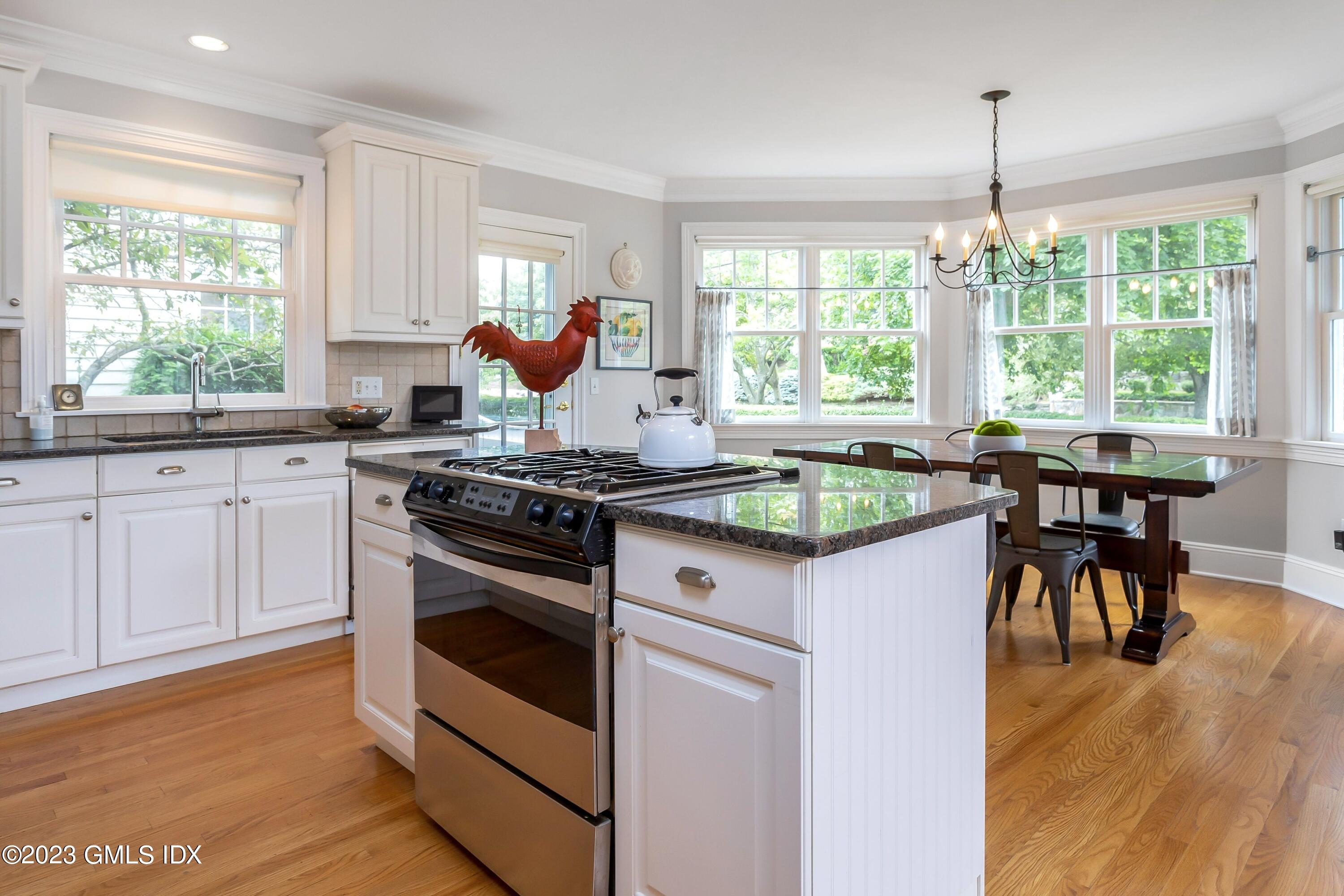 124 East Elm Street, Unit WEST Greenwich, CT 06830 - Photo 7 of 23 a kitchen with a stove a sink and cabinets