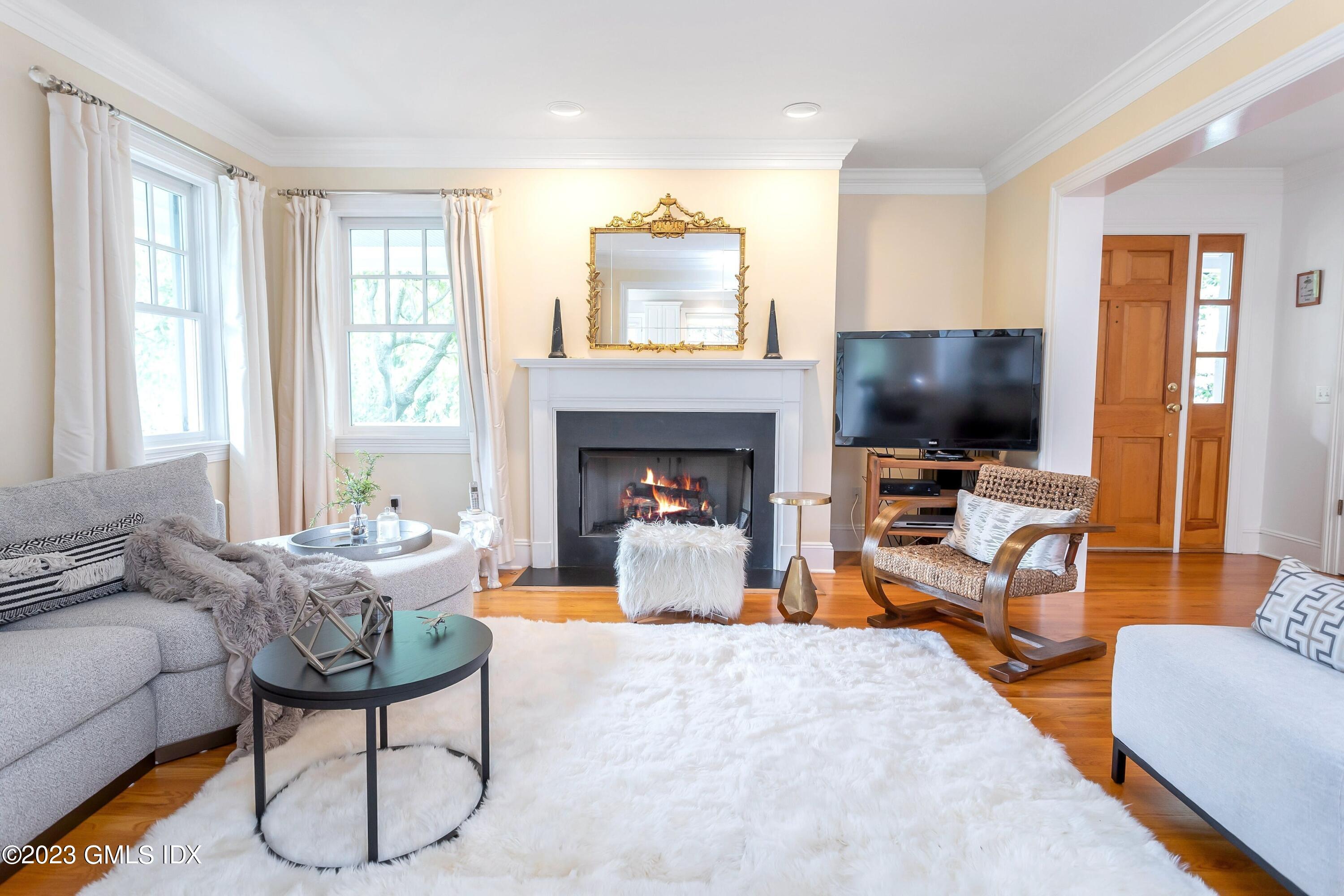 124 East Elm Street, Unit WEST Greenwich, CT 06830 - Photo 10 of 23 a living room with furniture and a flat screen tv