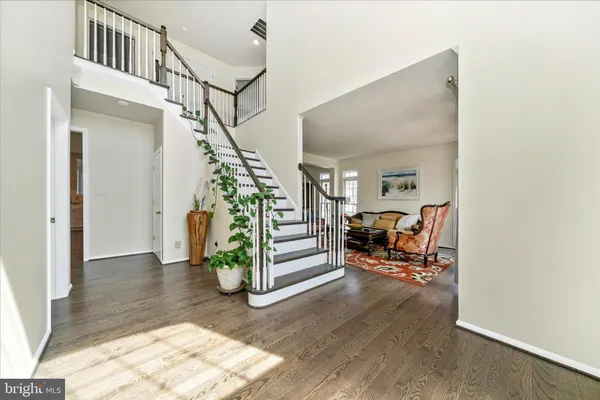 a large kitchen with stainless steel appliances lots of counter space and wooden floor