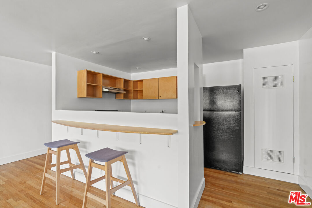 511 Rialto Avenue, Unit 4 Venice, CA 90291 - Photo 7 of 17 a kitchen with stainless steel appliances a refrigerator and wooden floor