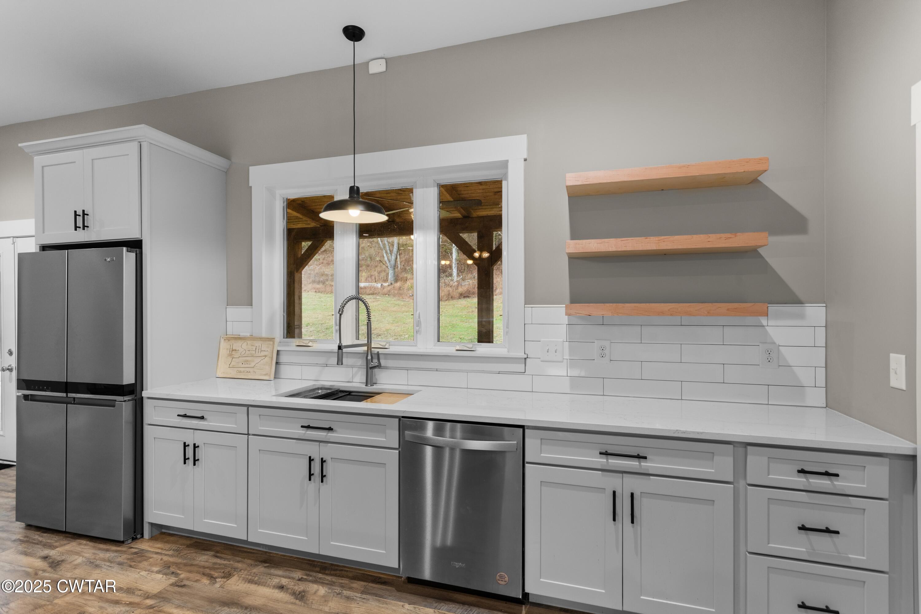 3154 Dodson Gap Road Culleoka, TN 38451 - Photo 11 of 36 a kitchen with appliances cabinets and a potted plant