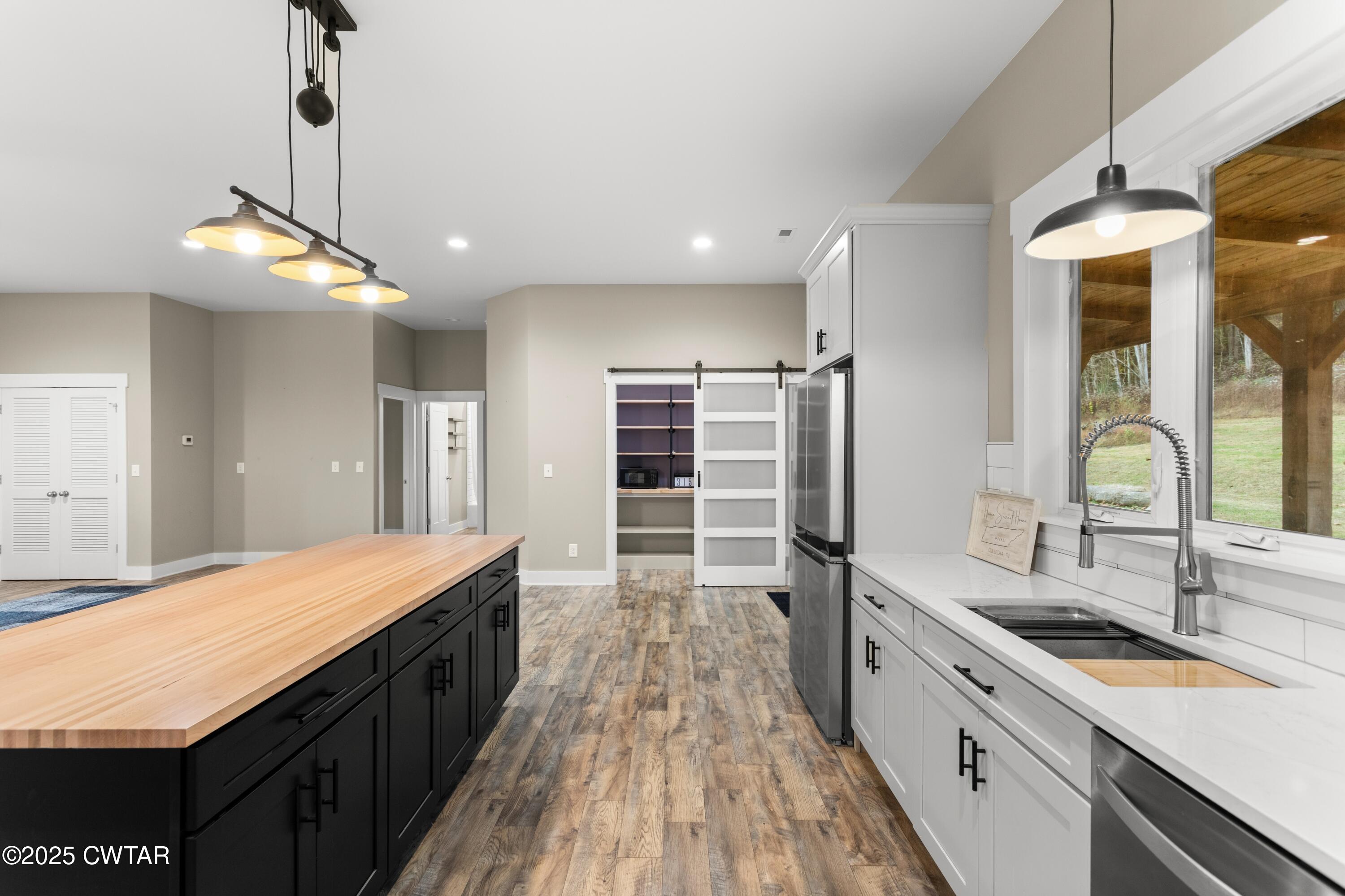 3154 Dodson Gap Road Culleoka, TN 38451 - Photo 13 of 36 a large kitchen with kitchen island a large counter space a sink appliances and cabinets