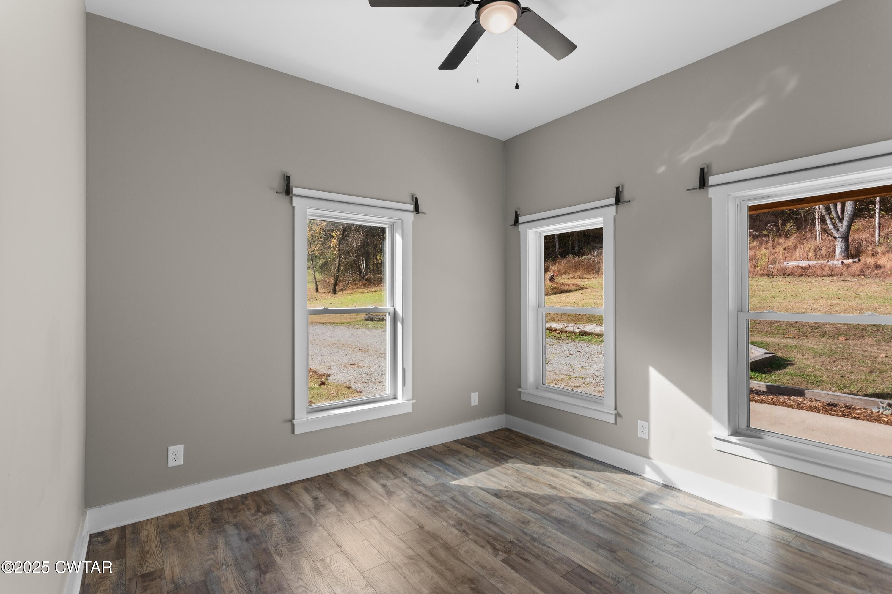 3154 Dodson Gap Road Culleoka, TN 38451 - Photo 22 of 36 a view of an empty room with a window and wooden floor