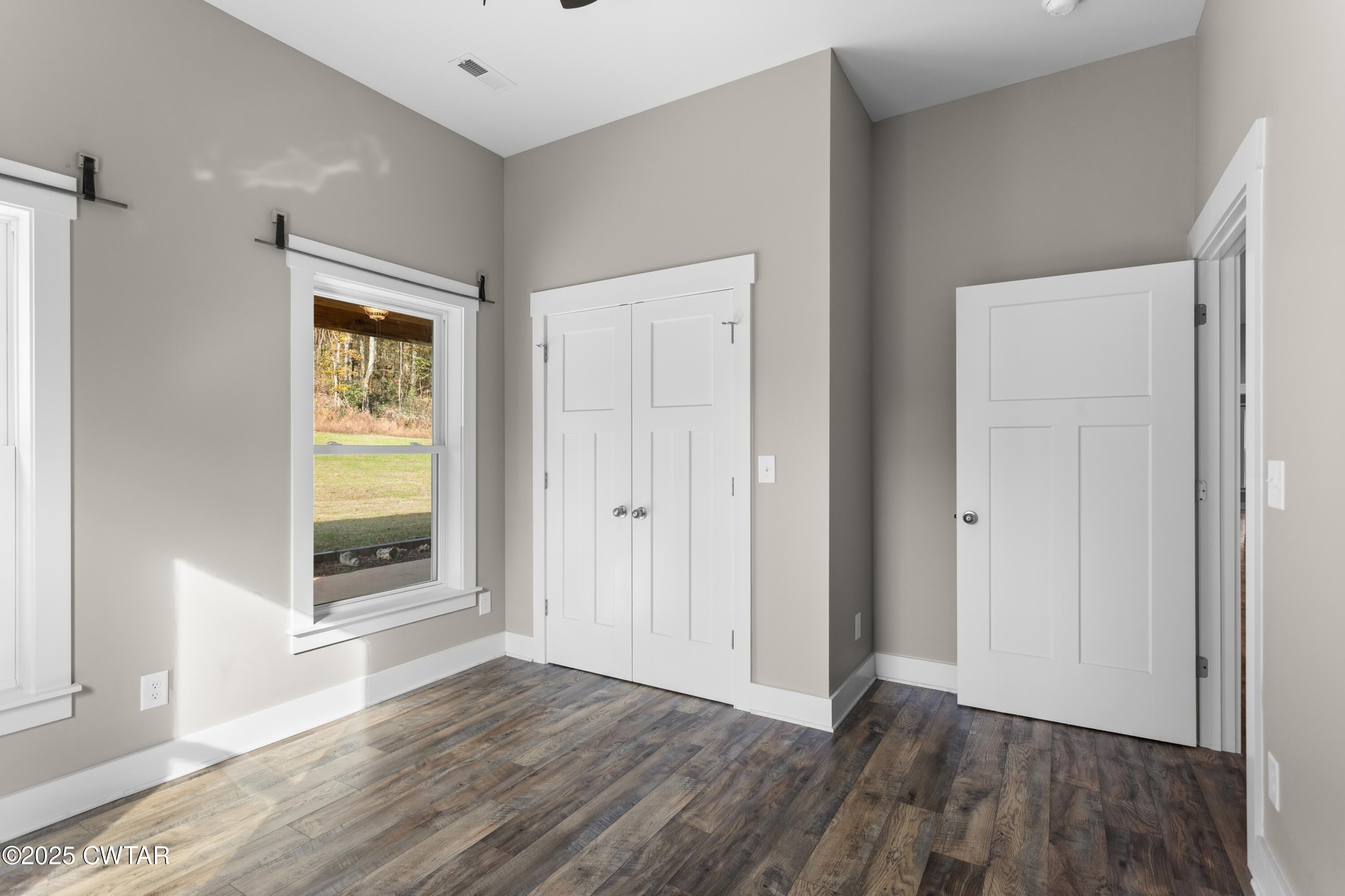 3154 Dodson Gap Road Culleoka, TN 38451 - Photo 23 of 36 a view of an empty room with wooden floor and a window