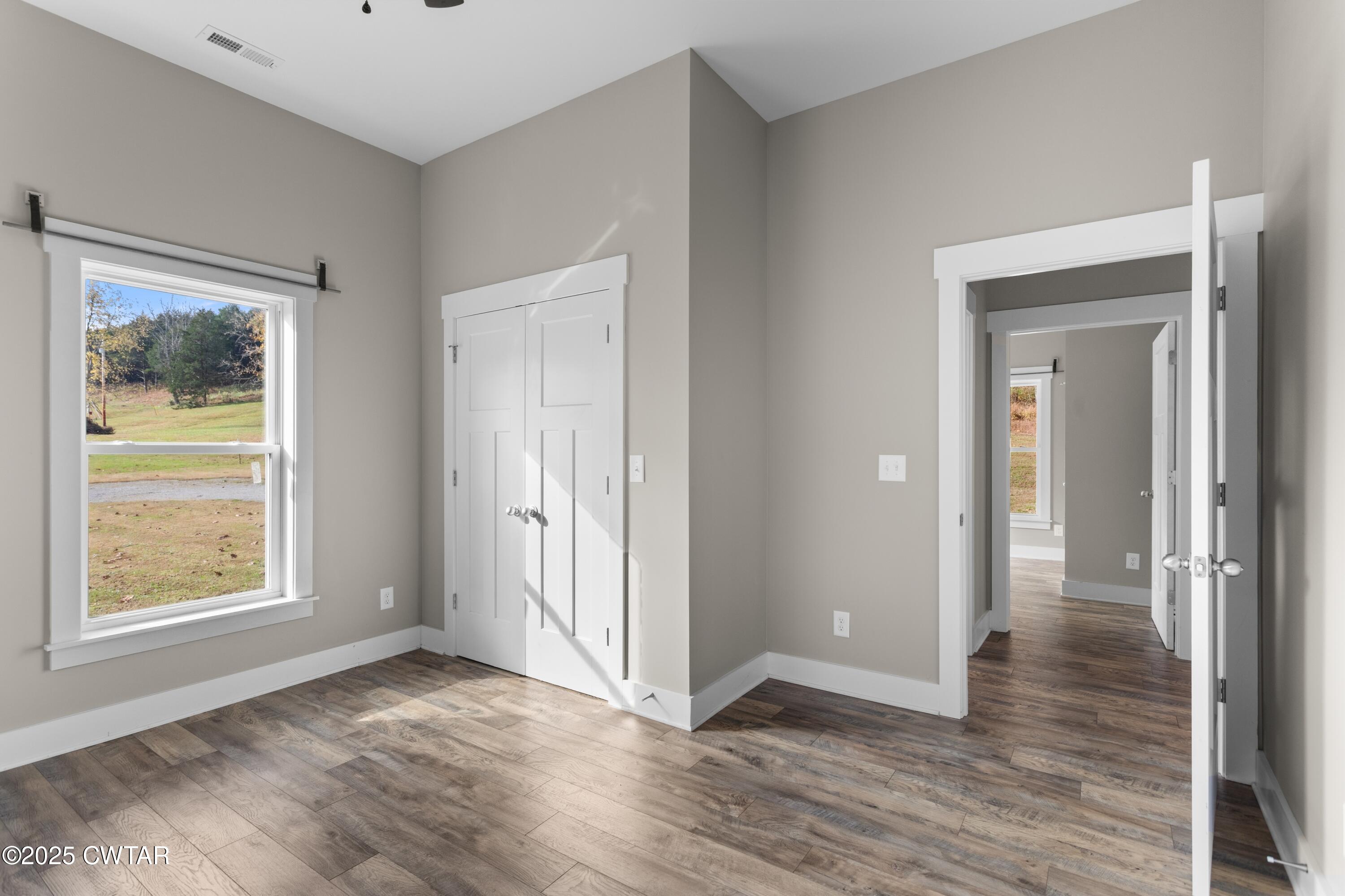 3154 Dodson Gap Road Culleoka, TN 38451 - Photo 26 of 36 a view of an empty room with window and wooden floor
