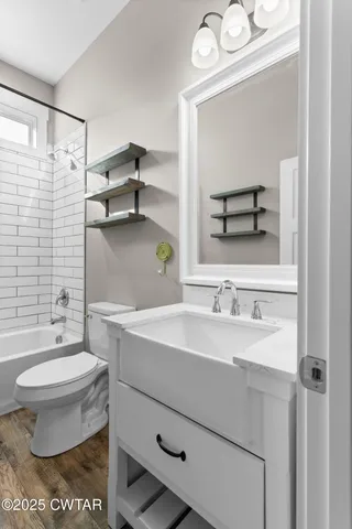 a bathroom with a sink toilet a mirror and shower